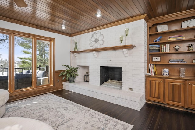 living room with a fireplace, ornamental molding, dark hardwood / wood-style flooring, and wooden ceiling