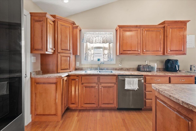 kitchen with vaulted ceiling, dishwasher, sink, and light wood-type flooring