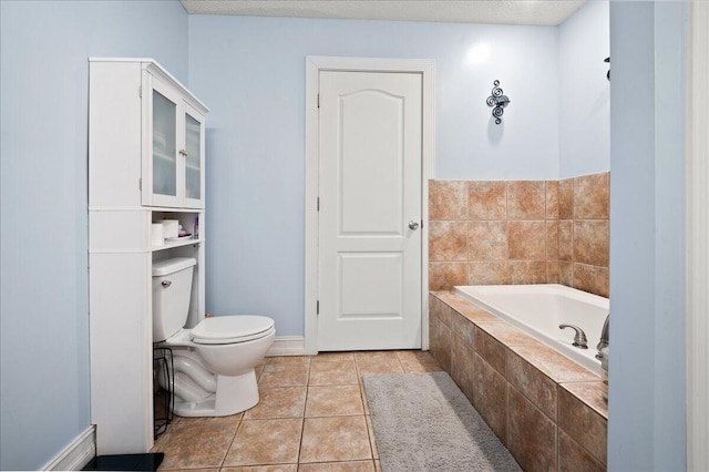 bathroom featuring toilet, tile patterned flooring, and tiled tub