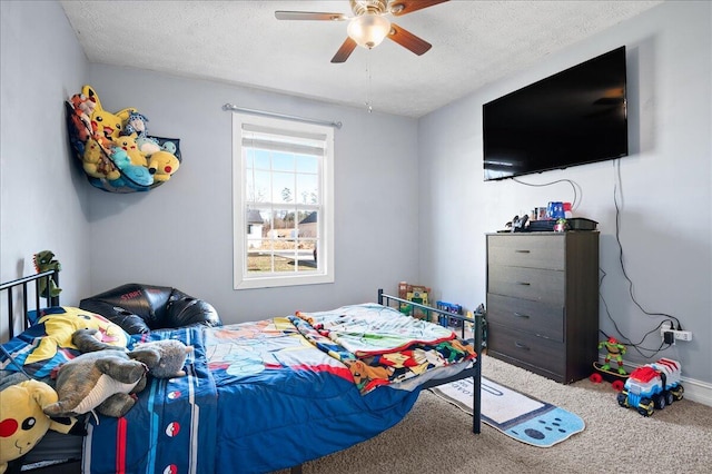 bedroom with a textured ceiling, ceiling fan, and carpet