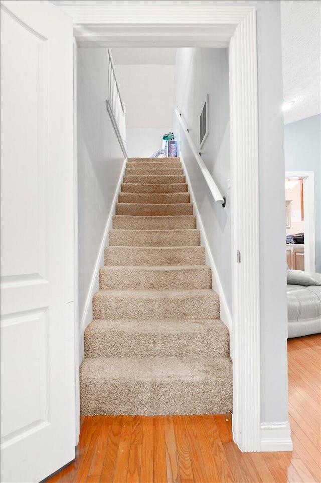 staircase featuring wood-type flooring