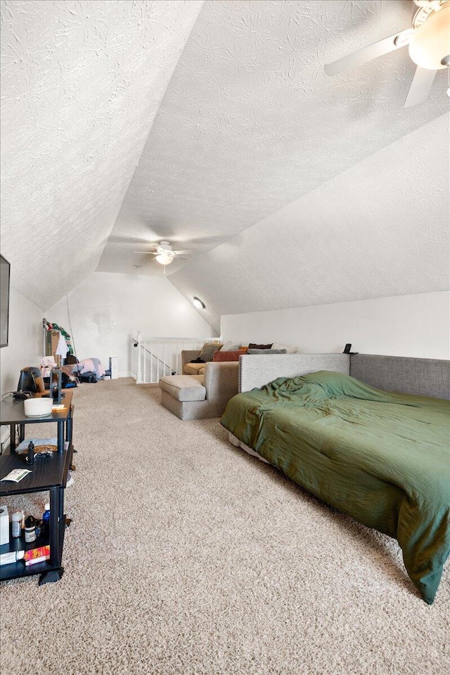 carpeted bedroom featuring ceiling fan, lofted ceiling, and a textured ceiling