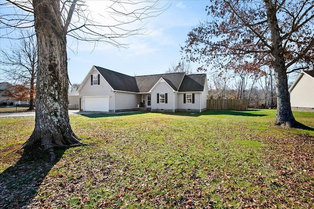 view of front of property with a garage and a front lawn