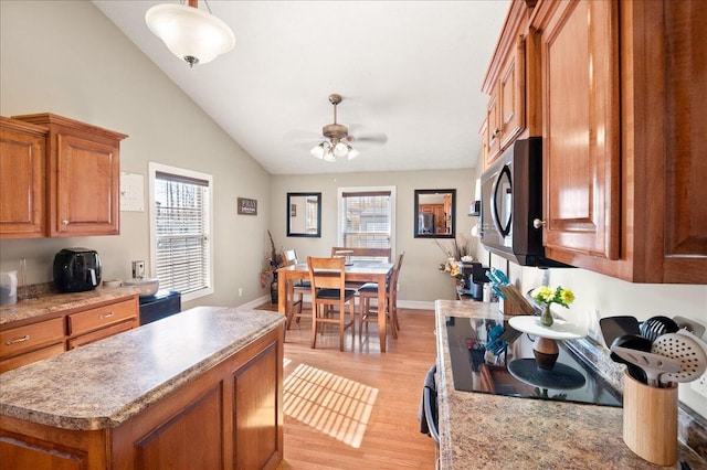 kitchen featuring pendant lighting, a wealth of natural light, ceiling fan, and light hardwood / wood-style flooring