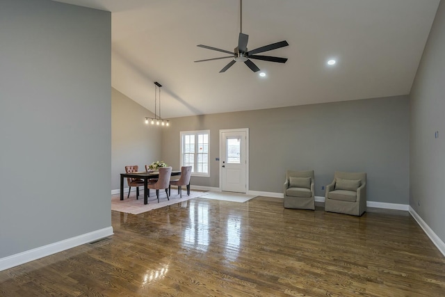 interior space with ceiling fan, high vaulted ceiling, and dark hardwood / wood-style flooring