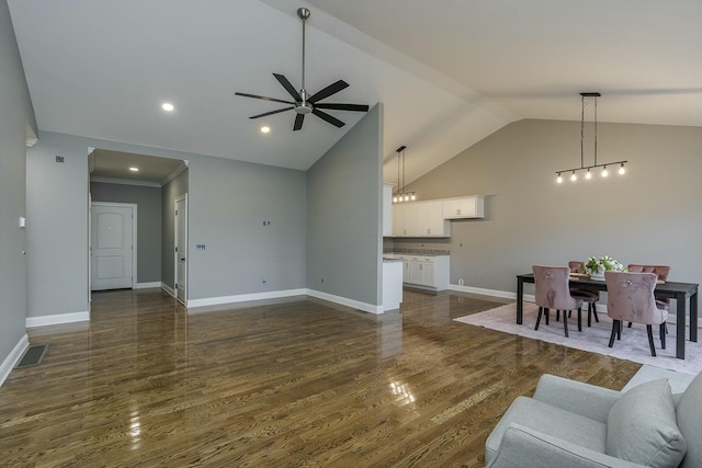 living room with dark wood-type flooring, lofted ceiling, and ceiling fan