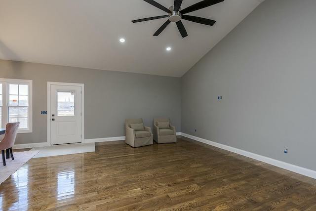 unfurnished room with ceiling fan, vaulted ceiling, and wood-type flooring