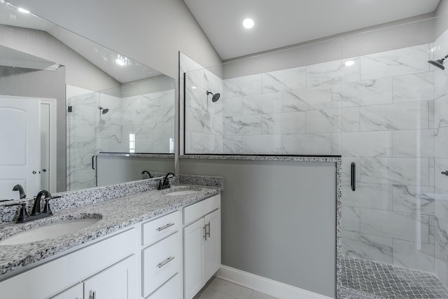 bathroom featuring lofted ceiling, a shower with shower door, and vanity