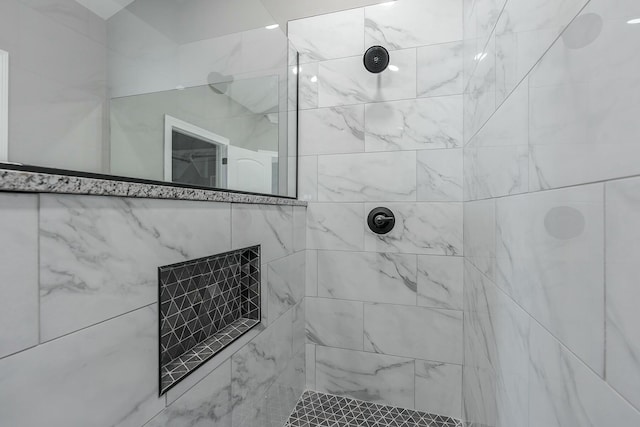 bathroom with tiled shower