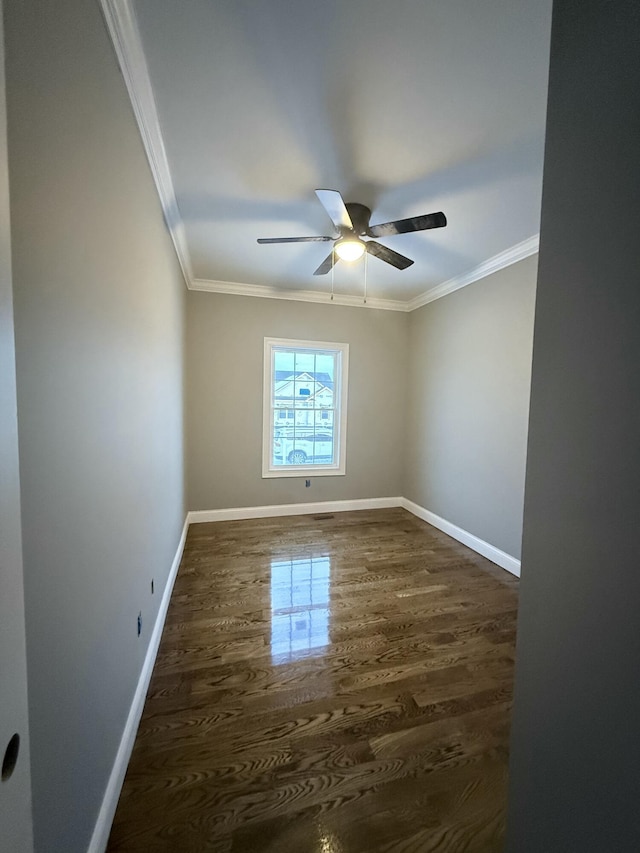 unfurnished room with dark hardwood / wood-style flooring, ornamental molding, and ceiling fan