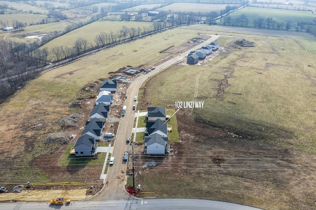 birds eye view of property with a rural view