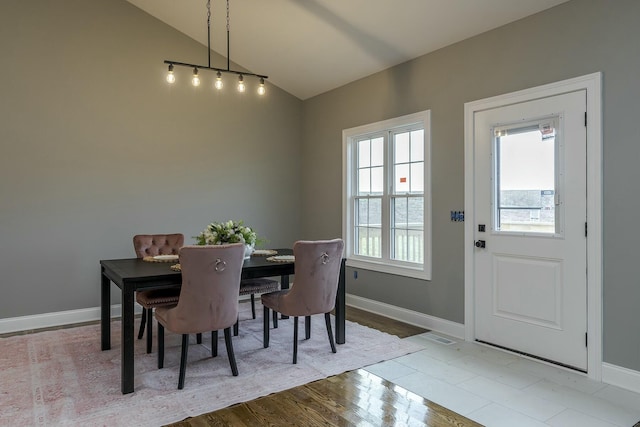 dining space featuring vaulted ceiling