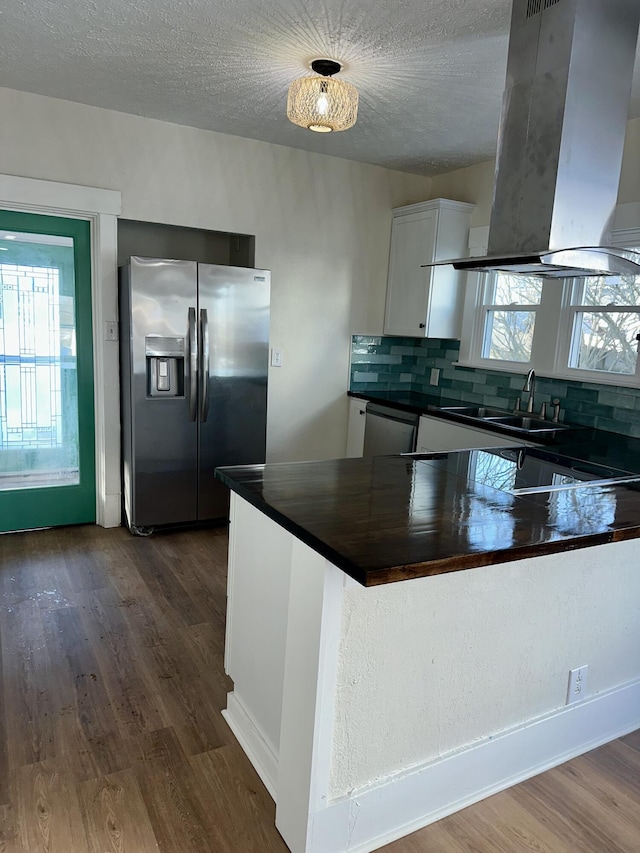 kitchen with sink, stainless steel appliances, dark hardwood / wood-style floors, white cabinets, and island exhaust hood