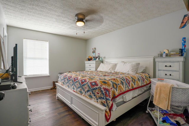 bedroom with dark hardwood / wood-style floors, a textured ceiling, and ceiling fan