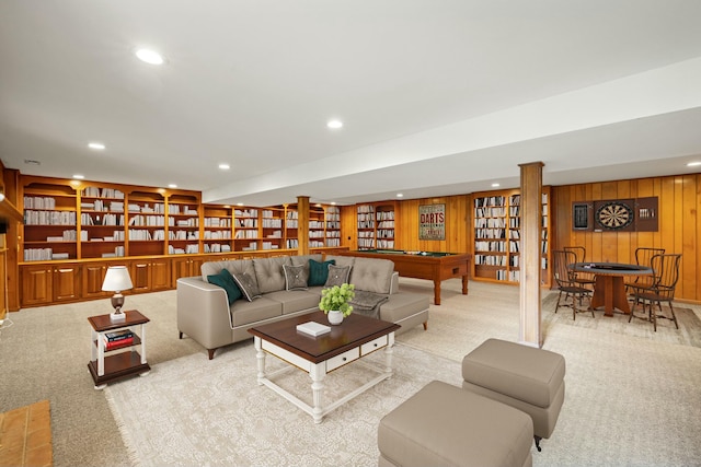 carpeted living room featuring billiards, built in features, and wood walls