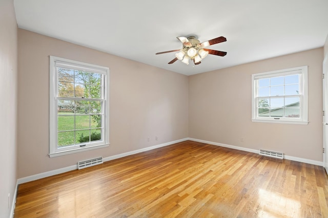 empty room featuring ceiling fan and light hardwood / wood-style flooring