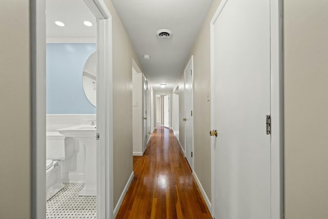 hallway with hardwood / wood-style flooring