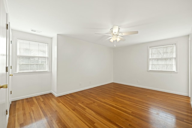 empty room featuring wood-type flooring and ceiling fan