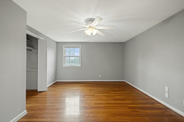 unfurnished bedroom with ceiling fan and hardwood / wood-style floors