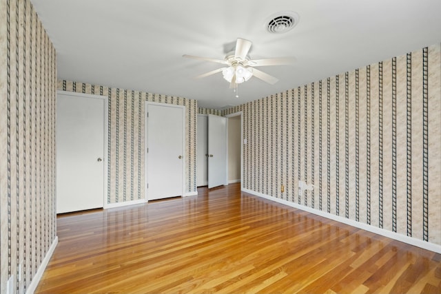 unfurnished bedroom featuring wood-type flooring and ceiling fan