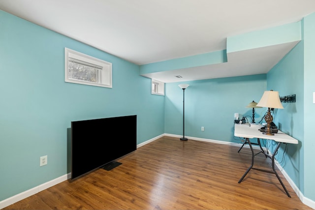 home office with wood-type flooring