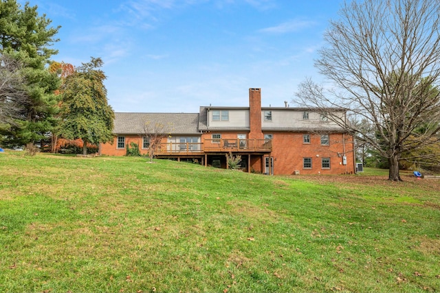 back of house with a deck and a lawn