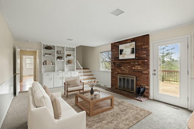 living room with ornamental molding, a brick fireplace, and light carpet