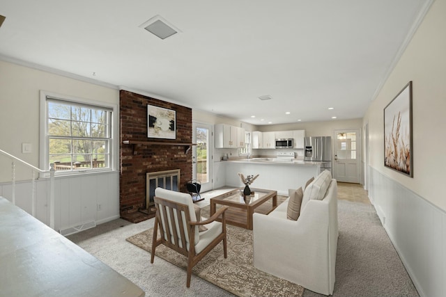 carpeted living room with a brick fireplace and crown molding