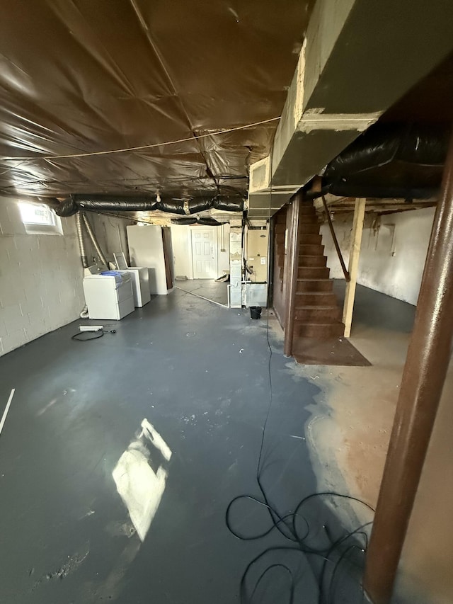 basement featuring washer and dryer and heating unit