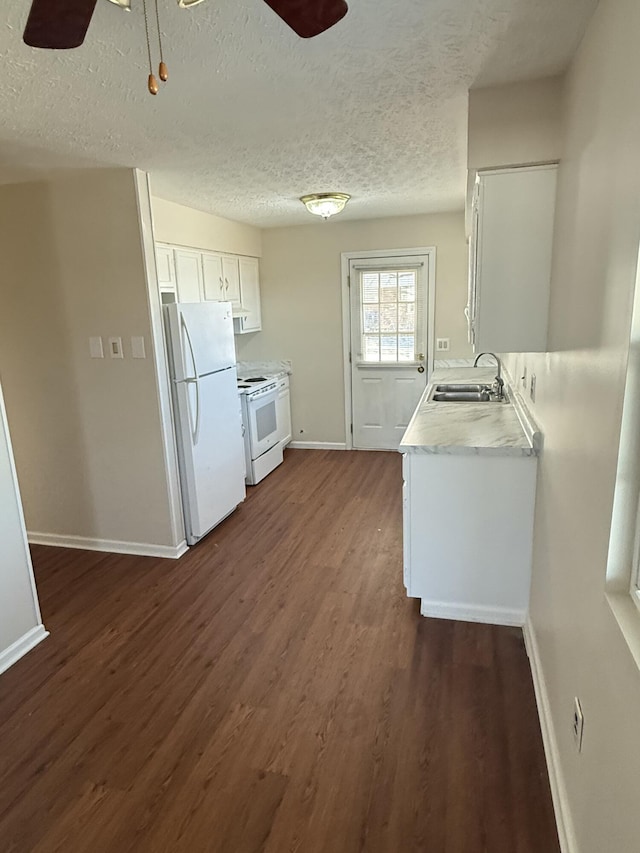 kitchen with white cabinetry, sink, ceiling fan, dark wood-type flooring, and white appliances