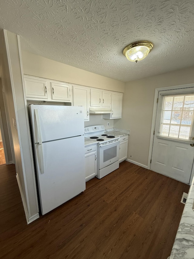 kitchen with dark wood-type flooring, white appliances, a textured ceiling, and white cabinets