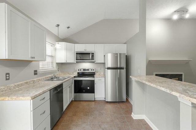 kitchen with stainless steel appliances, hanging light fixtures, and white cabinets