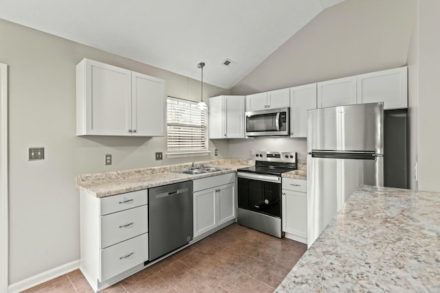 kitchen featuring lofted ceiling, sink, white cabinetry, decorative light fixtures, and stainless steel appliances