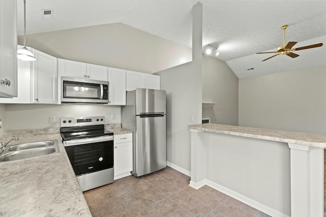 kitchen featuring white cabinetry, vaulted ceiling, stainless steel appliances, and a textured ceiling