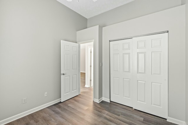 unfurnished bedroom with hardwood / wood-style flooring and a closet