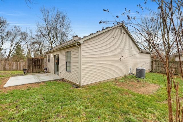 view of home's exterior featuring central air condition unit, a patio area, and a lawn