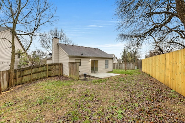 back of property featuring a yard and a patio