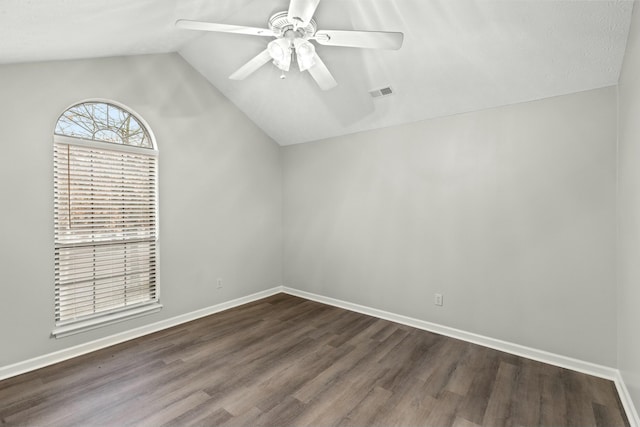 unfurnished room with lofted ceiling, dark hardwood / wood-style floors, and ceiling fan