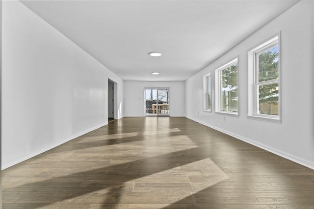 unfurnished living room featuring dark hardwood / wood-style floors