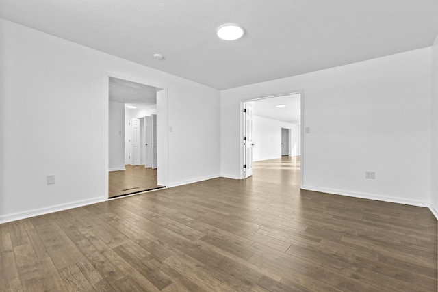 empty room with dark hardwood / wood-style floors