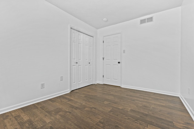 spare room featuring dark hardwood / wood-style flooring