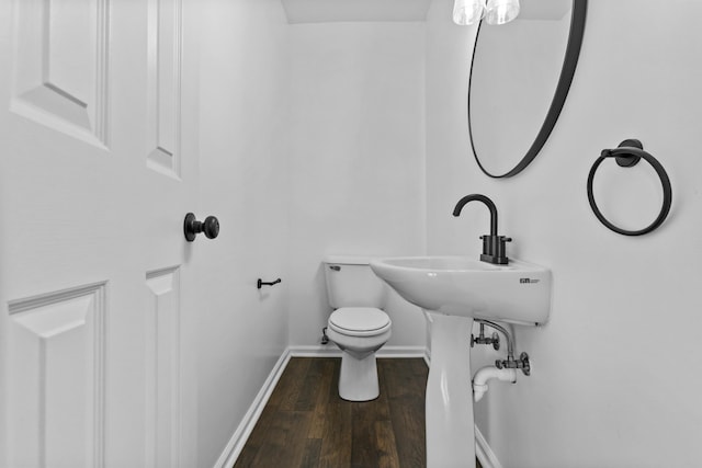 bathroom featuring hardwood / wood-style flooring and toilet