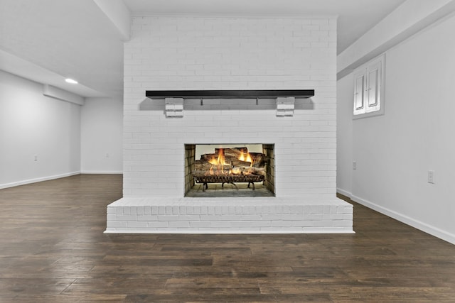 details with a brick fireplace and wood-type flooring