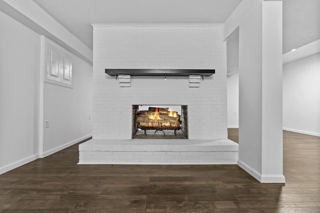 details featuring hardwood / wood-style flooring and a brick fireplace