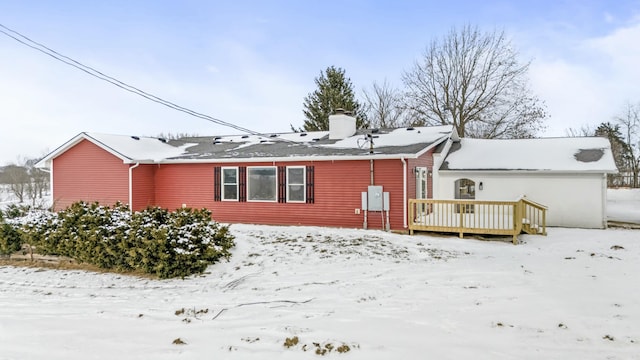 snow covered property featuring a wooden deck