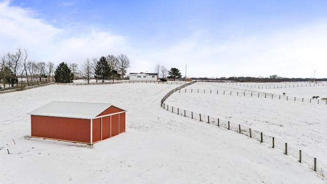 snowy yard featuring a rural view