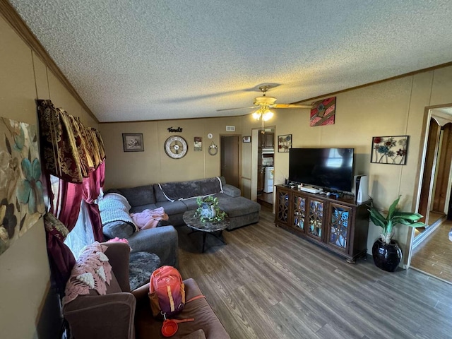 living room featuring hardwood / wood-style flooring, ornamental molding, a textured ceiling, and ceiling fan