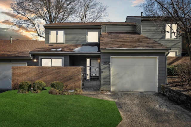 view of front facade featuring a yard and a garage