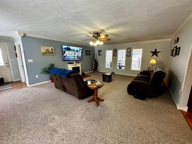 living room with crown molding, ceiling fan, a healthy amount of sunlight, and carpet