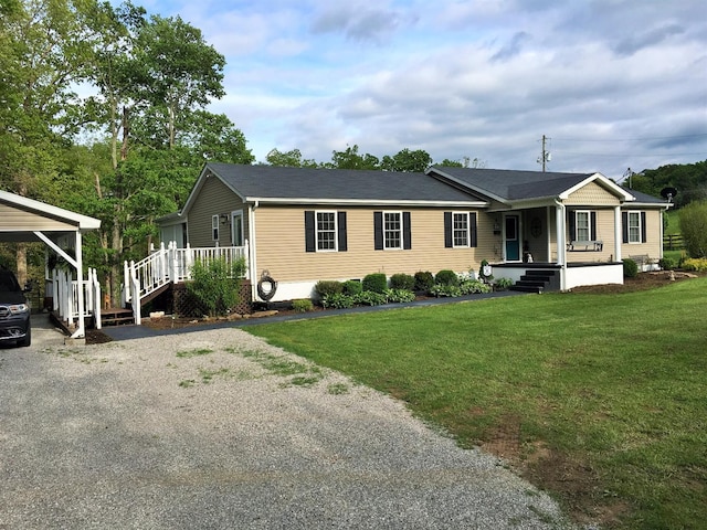 view of front facade featuring a carport, covered porch, and a front lawn